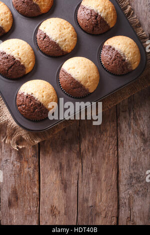 chocolate-orange muffins in baking dish from the oven. vertical top view Stock Photo