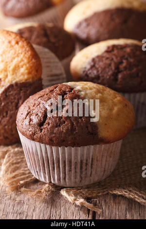 Delicious chocolate orange muffin on the table close-up, vertical Stock Photo