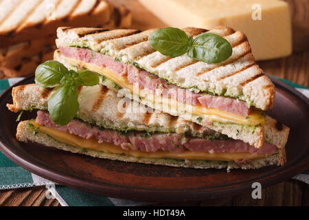 Hot toast with ham, cheese and basil close-up on a plate. horizontal Stock Photo