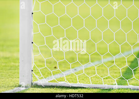 Soccer goal post and net detail on green turf Stock Photo