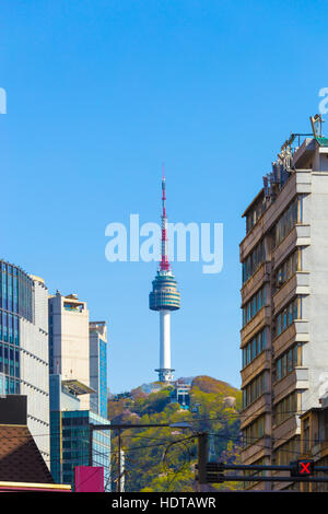 View from city center downtown to radio and tv tower, YTN or N Seoul Tower atop Namsan mountain on a clear, blue sky day Stock Photo