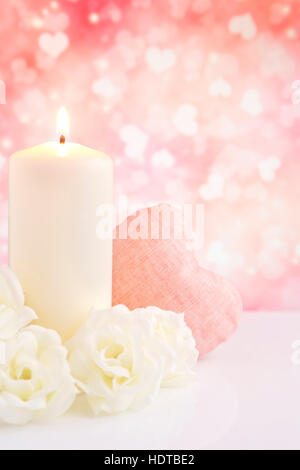 Valentine's hearts, candle and roses with a bright glittering background. Stock Photo