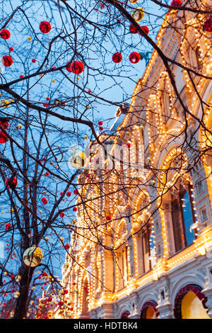 Christmas decorations in front of illuminated facade of the Central Department Store GUM on the Red Square in Moscow, Russia. Stock Photo