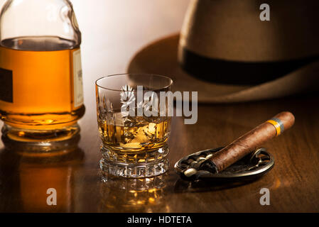 Whiskey and cigar on wooden background close up Stock Photo