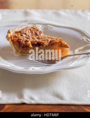 A slice of homemade pecan pie on a white plate with fork. Oklahoma, USA. Stock Photo