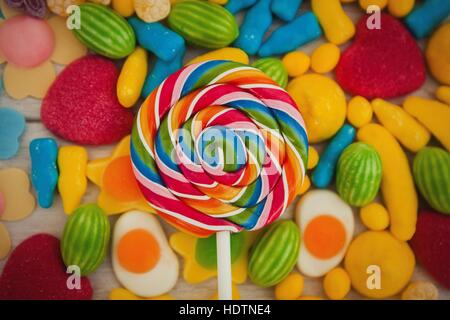 Round lollipop and many candies with different shapes and colors Stock Photo