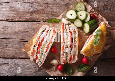 Pieces of chicken pie and fresh vegetables on the table. horizontal view from above Stock Photo