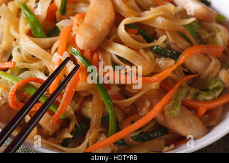 Delicious food: fried noodles with chicken and vegetables macro. horizontal Stock Photo