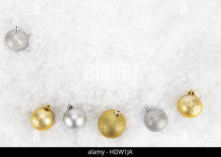 Gold and silver Christmas baubles isolated against white on abstract background Stock Photo