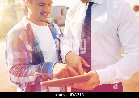 close up of builder and businessman with tablet pc Stock Photo
