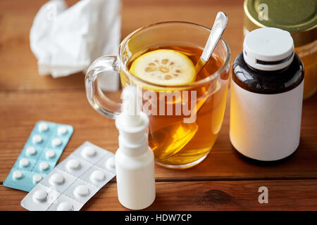 cup of tea, drugs, honey and paper tissue on wood Stock Photo