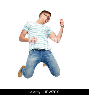 happy man jumping and playing imaginary guitar Stock Photo