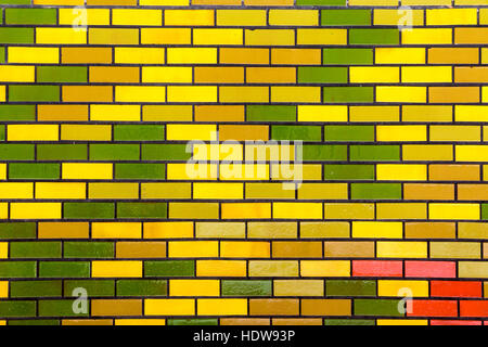 Close up of abstract red green and yellow painted rectangular pattern design and texture of brick wall background Stock Photo