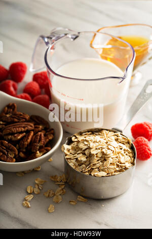 Cooking oatmeal with oats and milk Stock Photo