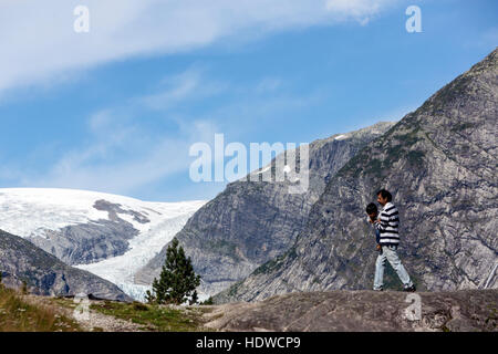 Tourist with children in Nigardsbreen glacier, Jostedalsbreen glacier. Gaupne, Luster, Sogn og Fjord Norway Stock Photo