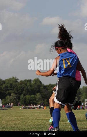 Two players in an Indiana summer league match between the girls' soccer teams of Blackhawk Christian & South Side high schools compete in Fort Wayne. Stock Photo