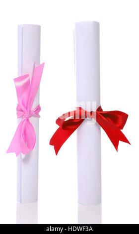 Two graduation diploma scroll tied with ribbon isolated on white background Stock Photo