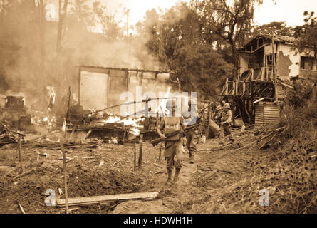 Leathernecks lead patrol between destroyed buildings in 'mop-up' of Wolmi Island, gateway to Inchon.  September 15, 1950.  Photo by Sgt. Frank C. Kerr Stock Photo