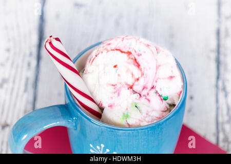 Peppermint ice-cream in a blue cup, rustic white background Stock Photo
