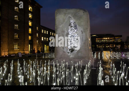 A Christmas tree suspended in a 'cube of ice' by British artist, Alek Chinneck, Granary Square, King's Cross, London, UK. Stock Photo