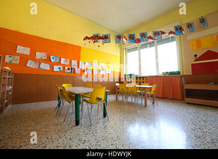 classroom of a kindergrten with drawings and the tables and small chairs Stock Photo