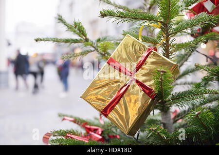 Christmas gift boxes in golden foil on the street Stock Photo