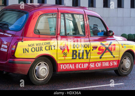 City of Liverpool LT1 red traditional  taxi with 'Do Not Buy the Sun' livery, illustration graphics in Merseyside, UK Stock Photo