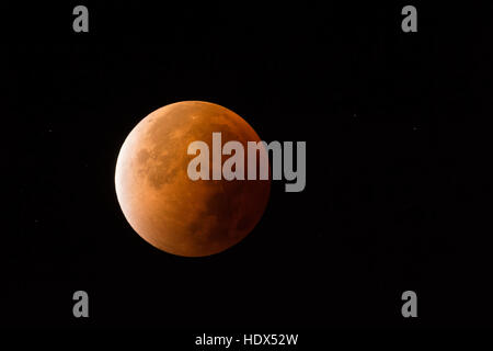 Lunar Eclipse, Red supermoon, Blood moon / Blutmond, red orange full moon with sparkling stars, 28th September 2015. Stock Photo