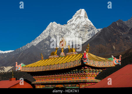 The entrance gate of the monastery Tengboche Gompa, the mountain Ama Dablam (6856m) in the distance Stock Photo