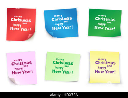 The colored pieces of paper with the message of Christmas greetings on white background Stock Photo