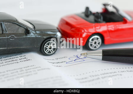 Insurance policy contract concept with toy model cars having a crash or accident Stock Photo