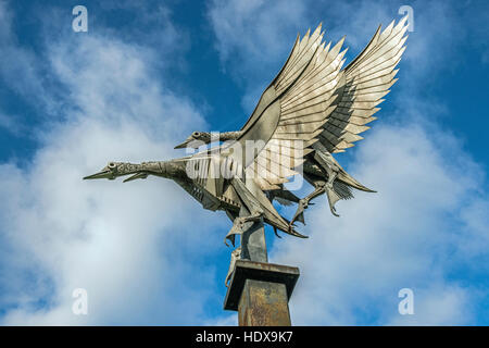 Statue, or metal casting, of three flying mallard ducks on the banks of the River Wye at Ross on Wye in Herefordshire, England Stock Photo