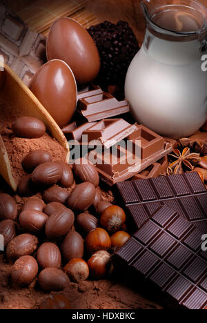 Easter eggs and assorted chocolate on wooden table Stock Photo