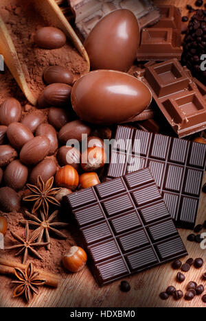 Easter eggs and assorted chocolate on wooden table Stock Photo