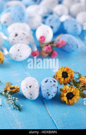 decorated eggs for Easter on blue table Stock Photo