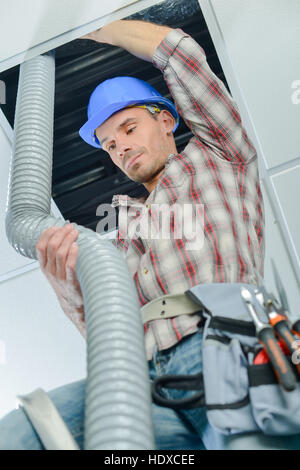 worker doing the ventilation system Stock Photo
