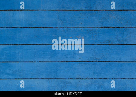 Wall from old boards painted with a blue paint. Stock Photo
