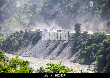 Trucks on a hillside road in Nepal Stock Photo