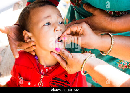 Young boy getting NGO distributed vitamin A drops in Kathmandu, Nepal Stock Photo