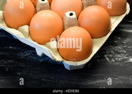 Fresh chicken eggs in box. Black background. Stock Photo