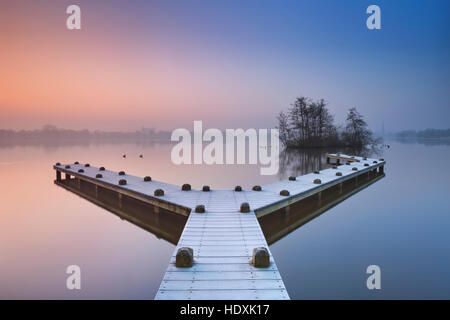A frosty jetty on a beautiful foggy morning in winter. Photographed in the Amsterdamse Bos (Amsterdam Forest) at sunrise. Stock Photo