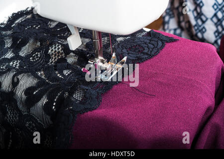 Sewing dress with machine Stock Photo
