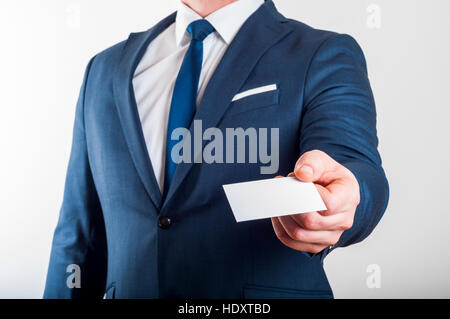 Businessman in suit is showing business card on white background Stock Photo