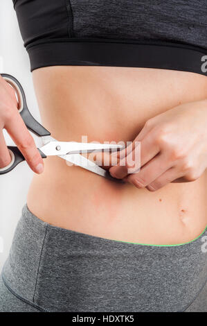 Woman with obesity holding scissors to the belly and cutting fat Stock  Photo - Alamy