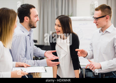 Happy attractive business group standing in an office Stock Photo