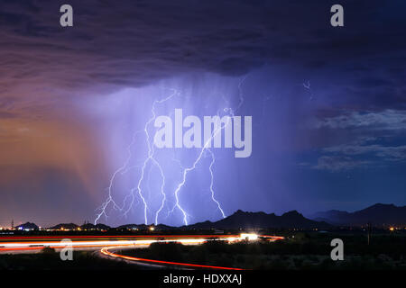 Series of lightning bolts striking a mountain during a thunderstorm in Tucson, Arizona Stock Photo