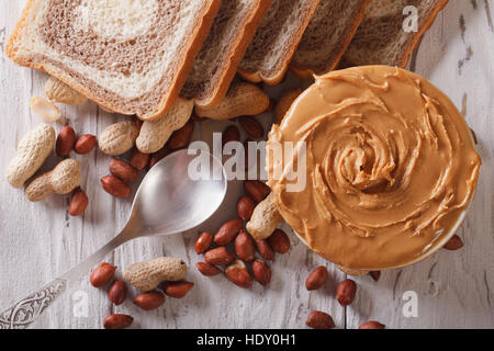 Peanut butter and bread on the table close-up. horizontal view from above Stock Photo