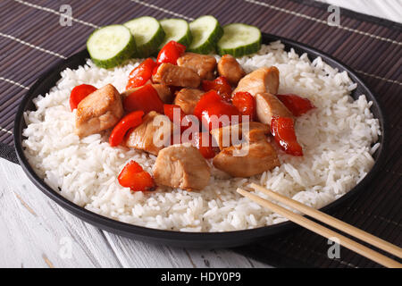 Rice with chicken pieces in a close-up of Asian style. horizontal Stock Photo