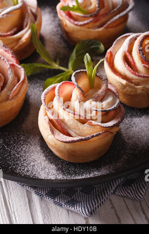 delicious apple dessert in the form of roses close-up. vertical Stock Photo