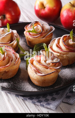 Delicious apple cake in the form of roses. Festive pastry, vertical close-up Stock Photo